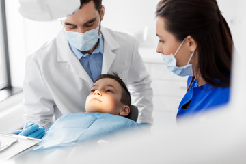 Sticker - medicine, dentistry and healthcare concept - dentist with mouth mirror checking for kid patient teeth at dental clinic