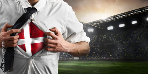 Denmark soccer or football supporter showing flag under his business shirt on stadium Poster