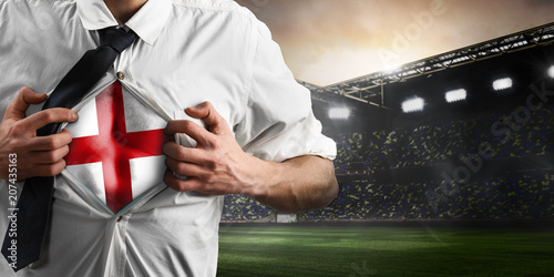 Fotografía England soccer or football supporter showing flag under his business shirt on stadium