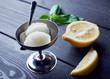 2 balls of homemade Lemon sorbet ice cream in metal bowl on black wooden background. Tasty summer dessert