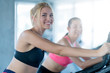 © whyframeshot - attractive caucasian girlfriend happiness time in gym workout on stationary bicycle with smile and fresh