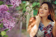 © Volodymyr Shcherbak - Beautiful woman in a spring garden with blooming lilacs