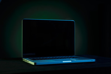 Portable modern silver computer on a black background.
