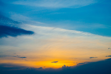 Wall Mural - beautiful early blue cloudy sky with orange sunlight. atmospheric cobalt background of colorful sunr