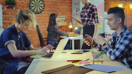 Computer programmers and web designers working in modern office IT company