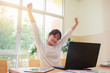 © smolaw11 - Young girl Student or Start up Adolescents ASEAN celebrate Hands up joy of accomplishing successful goal activities with happy smile expression positive emotion on desk computers in office