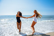 © javiindy - Two women in swimsuit having fun on the beach
