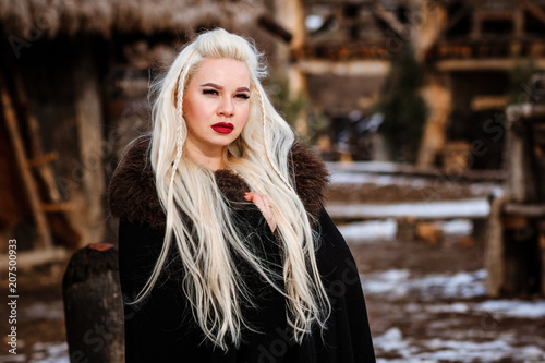 Fotografie, Obraz Beautiful young woman holding a viking with blond hair