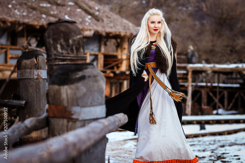 Fotografie, Obraz Beautiful young woman holding a viking with blond hair