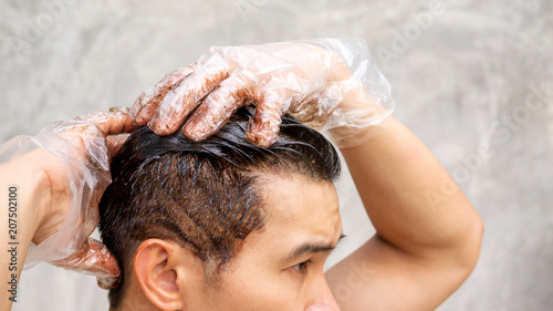 Asian Men Dye His Hair Color On A Gray Background Buy This