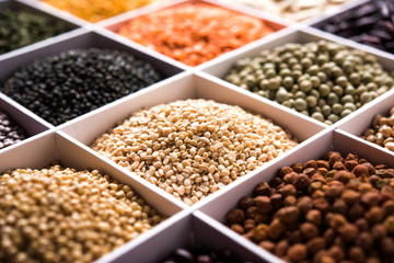 Indian Beans,Pulses,Lentils,Rice and Wheat grain in a white wooden box with cells, selective focus.