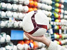 Hand With Soccer Ball In Sports Store