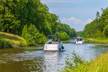 Motorboats On A Canal In An Idyllic Summer Landscape
