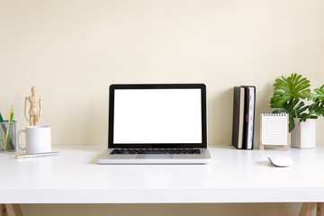 Fototapete - Mockup blank screen computer laptop on desk. Workspace with laptop and office supplies.