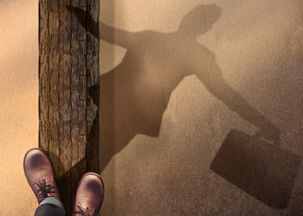 Wall Mural - Work Life Balance Concept. Top View of Male Standing and Balancing his body on Wooden Log at the Beach. Blurred Shadow on Sand as meaning