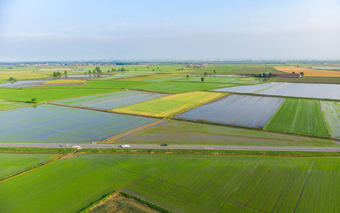 Aerial: rice paddies, flooded cultivated fields farmland rural italian countryside, agriculture occupation, sprintime in Piedmont, Italy