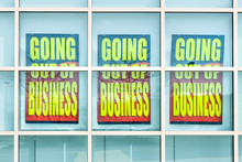 Closeup Of Yellow Store Closing Banner Poster Sign On Glass Window Of Store Building For Bankruptcy Going Out Of Business