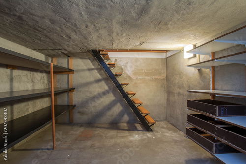 Cuadros en Lienzo empty basement in abandoned old industrial building with little light and a wood