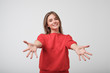 © Viktor Koldunov - portrait of attractive smile teenage girl raised up arms hands at you. She is dressed in red t-shirt. Happy to welcome a friend or guest