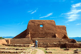 A tourist photographs the historic church at Pecos National Historical Park in New Mexico