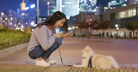 Canvas Print - Woman train her dog in city