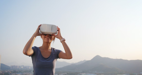 Wall Mural - Woman playing VR at outdoor