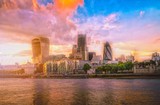 Fototapeta  - Skyscrapers of the City of London over the Thames river at sunset in England.