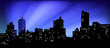 Black silhouette of cityscape. The beams of searchlights in the night sky.