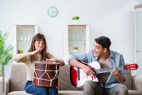 Fotografía Young family singing and playing music at home