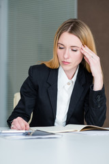 Wall Mural - headache stress tiredness concept. young business lady at work