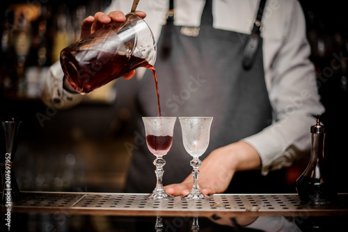 Fotografie, Obraz Barman pouring fresh summer Arnaud cocktail into the glasses