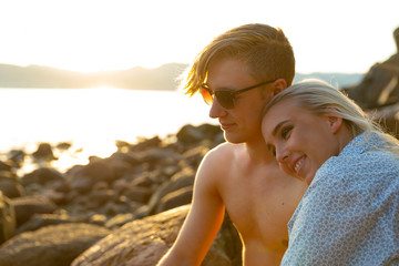 Wall Mural - Couple in love enjoy the sunset at the beach