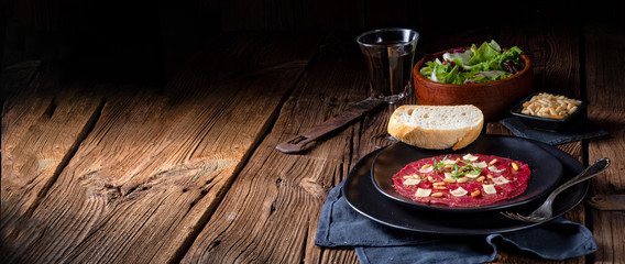 Wall Mural - Carpaccio of beef with pine nuts, colorful pepper and Parmesan cheese