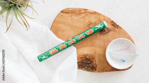 Fotografía Moxibustion roll (mugwort) used in Chinese medicine on wooden board with acupunc