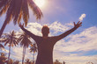 © astrosystem - Man enjoying tropical climate with arms wide open.