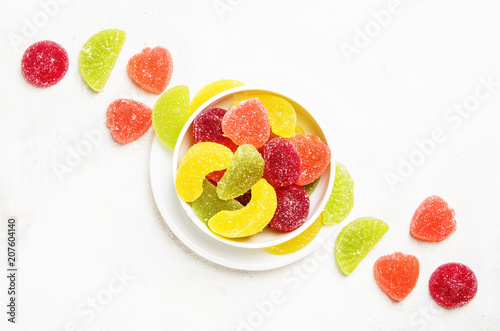 Plakat Multicolored marmalade in sugar, light background, top view