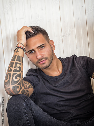 Handsome Green Eyed Young Man Relaxing At Home Sitting On His
