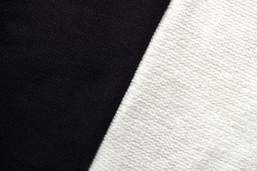 Close-up black and white knitted textiles for background. Top view textures of different fabrics. Minimalistic monochrome concept.