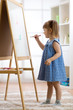 © Oksana Kuzmina - Kid girl drawing on white board at home