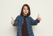 © Prostock-studio - Excited girl showing thumbs up on white background