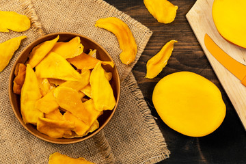 Wall Mural - Dried Mango Fruit on Wooden Background. Selective focus.