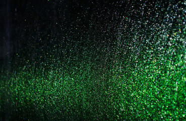 Wall Mural - green sparkling and shining star points on a black isolated background will create a festive mood