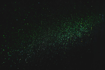 Wall Mural - green sparkling and shining star points on a black isolated background will create a festive mood