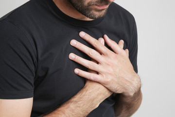 Chest Pain, Young man holding hand to spot chest pain