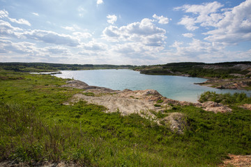 Wall Mural - Flooded open pit quarry lake ore clay mining with blue water