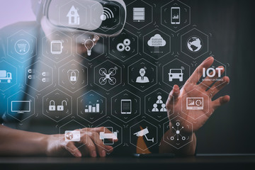 Poster - businessman wearing virtual reality goggles in modern office with Smartphone using with VR headset