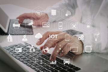 Poster - close up of businessman typing digital tablet with keyboard and laptop computer on white desk in modern office