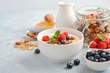 Homemade granola with yogurt and fresh berries, healthy breakfast concept, selective focus.