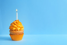 Delicious Birthday Cupcake With Candle On Color Background