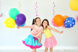 Adorable little girls at birthday party indoors
